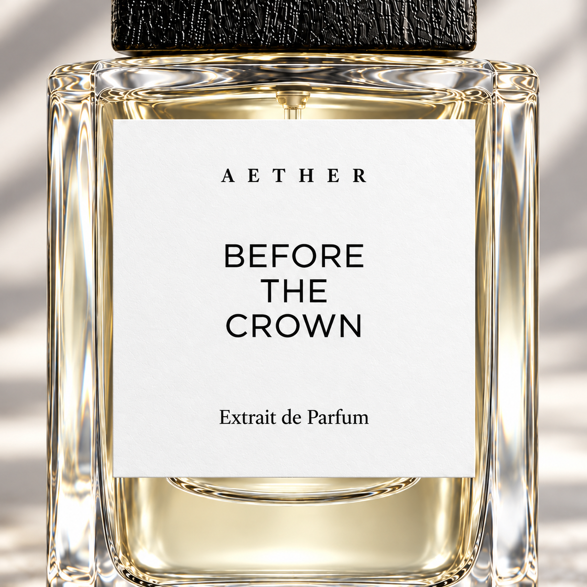 Close detail of the 01 Before The Crown bottle: white label, glass and textured black cap