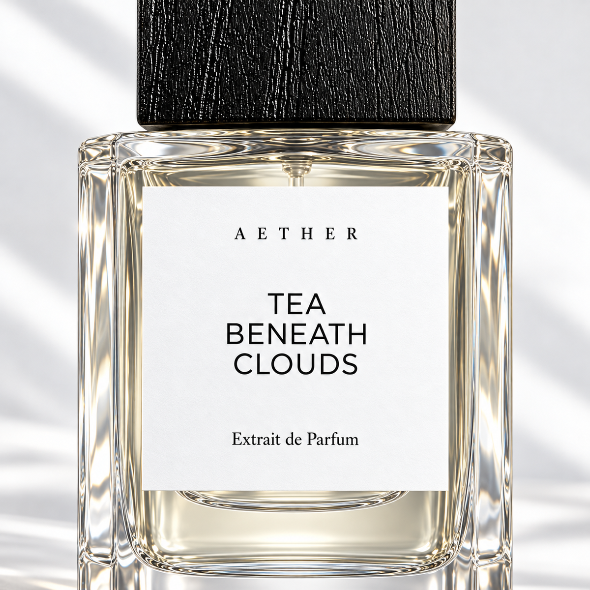 Tea Beneath Clouds Extrait de Parfum — close detail of the white label and glass