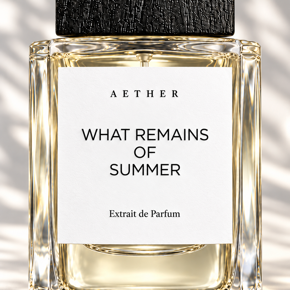 What Remains of Summer Extrait de Parfum — close detail of the white label, glass and textured black cap